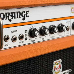 Detailed shot of the control panel on an orange bass amps, highlighting the EQ knobs and input jacks, essential for shaping bass tones.