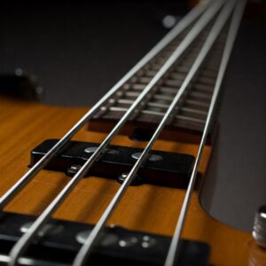 The five strings on the neck of a yamaha 5 string bass guitar.