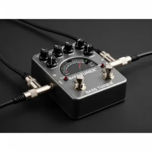 "A bass tuner pedal shown with input and output cables connected, illustrating its simple integration into a bass guitar signal chain."