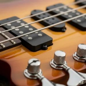 Detailed view of the pickups and tuning pegs on a Cort bass, illustrating the quality hardware and electronics that contribute to its distinctive tone.