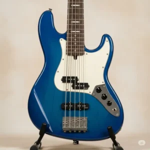 A vibrant blue Cort bass guitar resting on a stand, showcasing the range of appealing finishes available for Cort bass models.