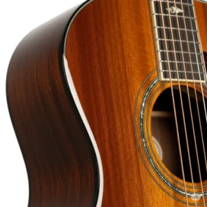 a detailed view of the rich, glossy finish on the body of a new Jasmine acoustic guitar.