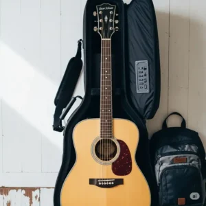 An acoustic oscar schmidt guitar with a gig bag, ready for a trip.