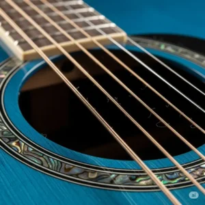 A macro shot of the steel strings and soundhole of a blue acoustic guitar, focusing on the subtle details of the instrument's construction.