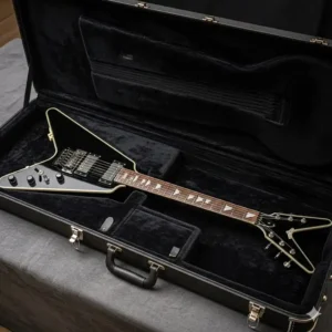A Dean Cadillac guitar resting securely inside a fitted hard-shell case.

