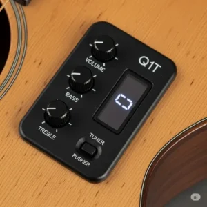 The built-in Godin Q1T electronics system on a Seagull acoustic guitar, with a close-up of the preamp and controls.