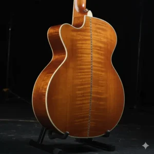 The stunning arched flamed maple back and sides of a Guild 12 string guitar, known for its powerful projection. 