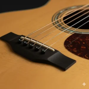 Close-up on the ebony bridge and bone saddle of a high-quality flat top guitar. 