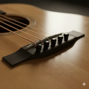 The characteristic bridge and ebony pins on a high-end Collings acoustic guitar.