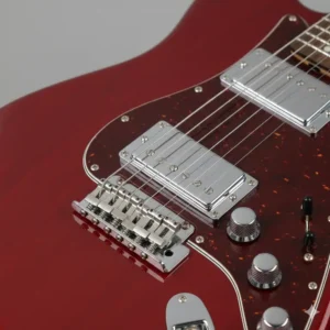 Close-up view of the bridge, volume and tone knobs, and the toggle switches on the body of the Fender Lead II guitar.