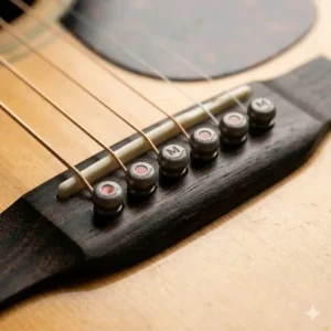 High-tech Luxe Liquidmetal martin bridge pins showing the metallic finish and red dot inlay.