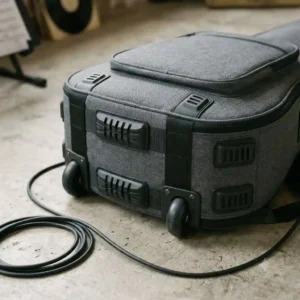 An electric bass guitar resting safely and snugly inside the open compartment of the best bass guitar gig bag.